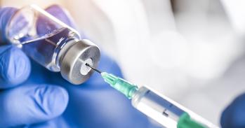 Syringe in bottle of vaccine.