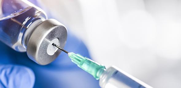 Syringe in bottle of vaccine.